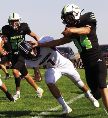 MHC’s Sawyer Dibbern stiffarms a Hitchcock County tackler.