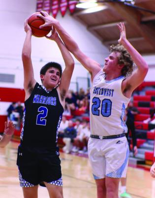 Southwest’s Kaiden Ruggles challenges the shot of Arapahoe’s Campbell Schutz in the lane Tuesday.