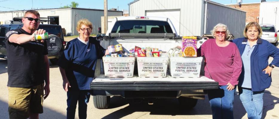 Pictured with donations collected during the Stamp Out Hunger event are rural carrier Chris Einsphar, Susan Rhynalds with the Oxford Food Pantry, rural carrier Val Percival and Oxford Clerk Terrie Jackson.