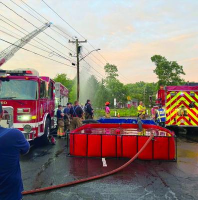 Recently, the Oxford Fire Department held its monthly department drill at Center Fire Station, focusing on water supply operations. Because many areas of town do not have hydrants, firefighters must be prepared to transport water to fire scenes. This training was divided into three stations, each targeting a key part of the process. Crews practiced filling tankers from the nearest available hydrant, transporting water to a portable pond, and then drafting that water to supply an engine or ladder truck 