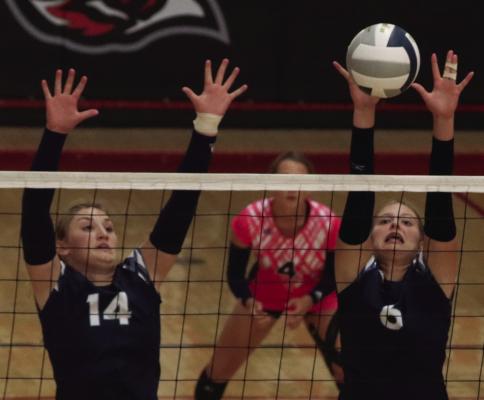 Southwest’s Atleigh Nelms and Kyra Nelms rise to block an attack.