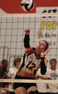 Cambridge’s Erin Johnson swats an attack.