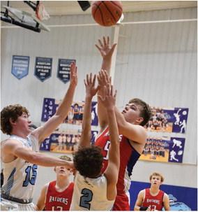 Med Valley’s Austin Roblee pulls up for a jumper over a pair of Southwest defenders.
