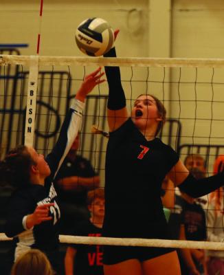 Cambridge’s Leah Downer stuffs a tip attack from Bancroft-Rosalie Saturday.