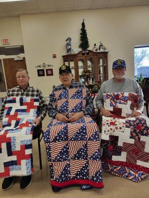 (L-R) Stan Knuth (Marines 1975-1977) His quilt was pieced and bound by Kathy Wilkins and quilted by Alice Erickson. Ton Ludeke (Army 1962-1964). His quilt was quilted by Barbara Shie and Marilyn Ellner of Holdrege and bound by Marilyn Lingg of Alma. Don Kaup (Air Force 1970-1973). His quilt was made by Sue Seeley, quilted by Barbara Shie, and bound by Sandy Dahlgren.