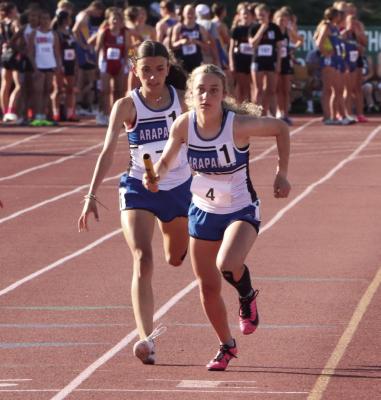 Warrior Peyton Sich hands off to Grace Andrews in the Arapahoe girls’ state 4x4. Andrews also ran the two-mile.