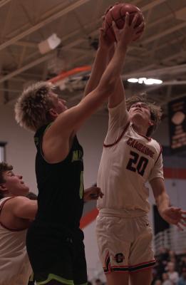 MHC’s Oliver Anders goes up to score while Cambridge’s Hodge Raburn challenges the shot.