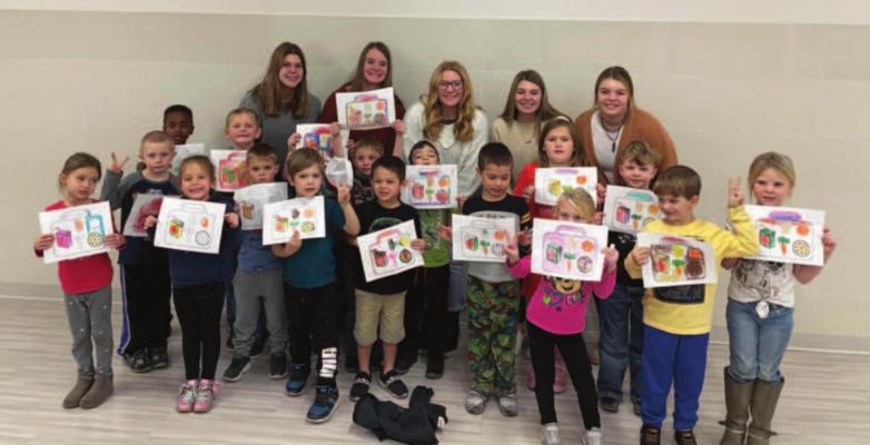 FFA Members (Back row: Left to Right) McKenzie Holiday, Tracy Roskop, Gentry Warner, Berkley Warner, and Hope Koller, read the children’s book “How did that get into my lunchbox?- the story of food” to the kindergarten class of Arapahoe Elementary. FFA members put together snack packs for the students that involved many of the food items discussed in the book, as well as a coloring activity.