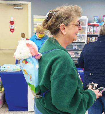 Pictured top - Jan McCracken made the trip from Edison to take part in the Teddy Bear Mobile at the Oxford Library on Saturday, January 22. Pictured right - Booker Bergquist looks at all the choices of stuffed animals.