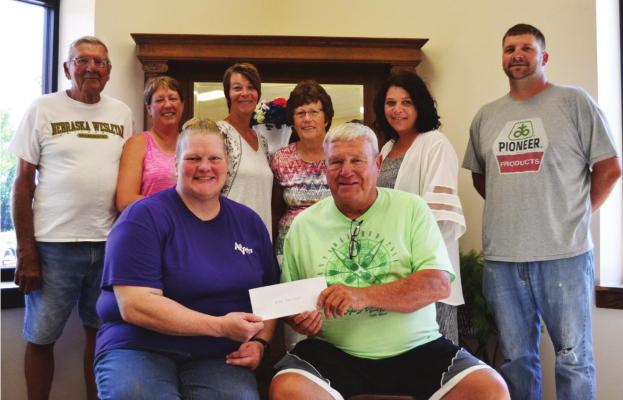 Oxford - Michelle Haag of the Oxford Area Foundation presents a check to Nate Stineman of the Golden Generation Board $10,000. Also pictured in the back row are: L to R - Ron Ludeke of the foundation, Margaret McInturf, Tina Hutchens, Jean Lisec, Heather Linden all of Golden Generation, and Eric Billeter with the foundation.
