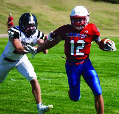 Medicine Valley’s Brody Senff tries to break free from a tackler.