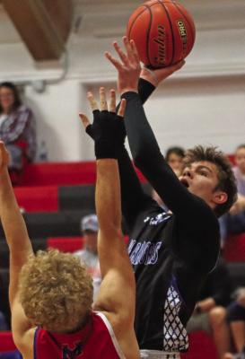 Arapahoe’s Kade Fisher scores over a Med Valley defender.
