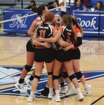 Cambridge players celebrate a semifinal victory over Alma, which sent the Trojans to their first RPAC final since 2007.