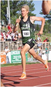 Oliver Anders of Maywood-Hayes Center ran the second leg of his team’s 4x4 relay at Burke Stadium.