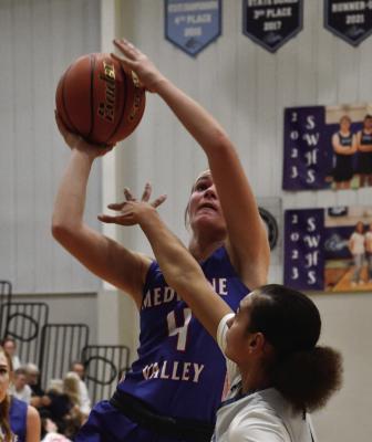 Remmi Stout (above) and Stella Heapy (below) take shots for Medicine Valley.