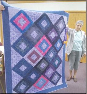 Penny Peterson of Curtis with the Grand Champion Quilt, named #10, that she entered in the Frontier County Fair at Stockville.