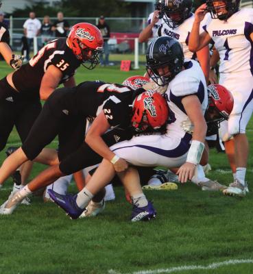 Cambridge’s Tye Stanton drives down a Hitchcock County ball carrier Friday night.
