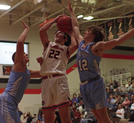 Cambridge’s Brohdey Wood rises for a shot against two Southwest defenders.