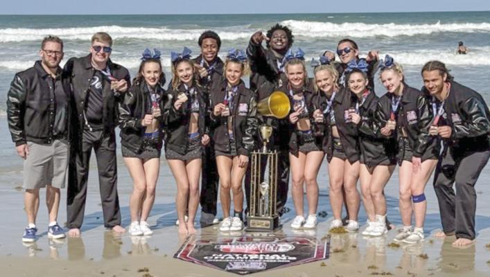 The Peru State competitive cheer team celebrated their national championship on the beach. In the photo (L to R): Interim Coach Joseph Gogus, Kohl Rutherford, Talia Case, Olivia Messer, Jeremy Porter, Nevaeh Wills, Gerald Lewis, Regan Wondercheck, Micaela Houseman, Daxx Bender, Sydney Cecil, Madison Eller, and Quinton Rowell.