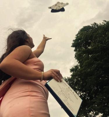 Arapahoe Valadictorian, Lauren Moore throws her cap in the air after the graduation ceremony on Saturday, May 16.