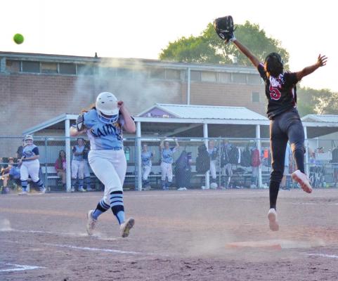 An SVA baserunner, Carlyn Stephen, ducks out of the way of a wayward throw against Chadron.