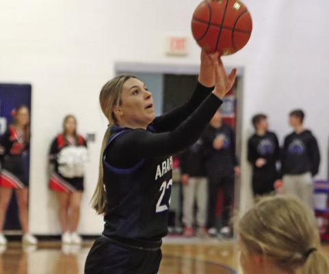 Arapahoe’s Berkley Warner fires a jumpshot.