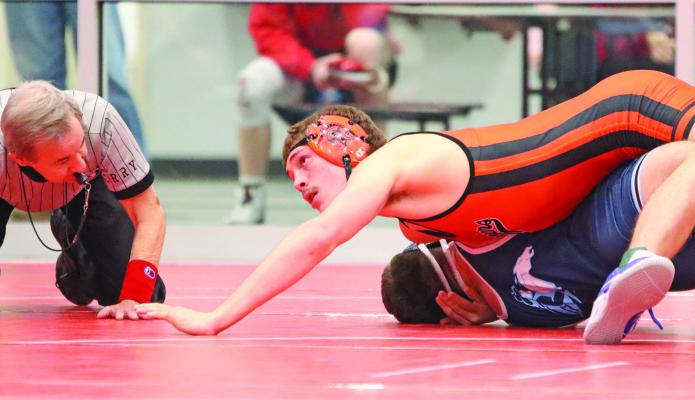 Cambridge’s Colton Perks earns near-fall points during a first round match en route to a first-place finish at 165 pounds.
