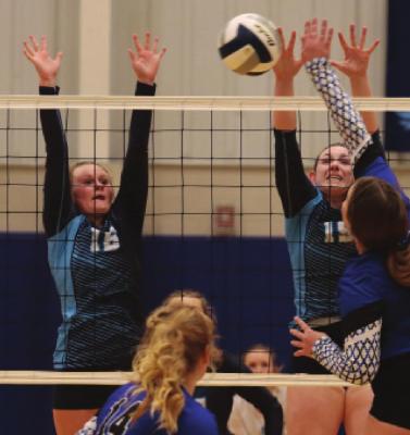 Payton Truksa and Caylin Barnett rise for a block.