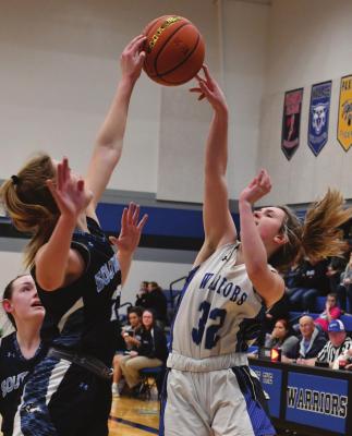Southwest’s Atleigh Nelms rises to block the shot of Arapahoe’s Rylee Bahe.