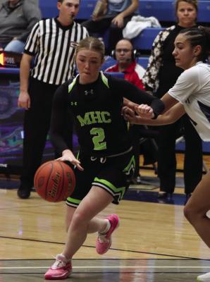 Maywood-Hayes Center’s Ellie Broz attacks the paint on the dribble.