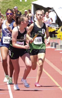 Karissa Stengel of Maywood-Hayes Center hands the baton off to teammate Caylie Softley in the 4x8.