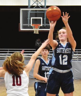 Southwest’s Bailey Truksa pulls up for a jumper in the lane over a closing Hi-Line defender, Kaydee Diefenbaugh.