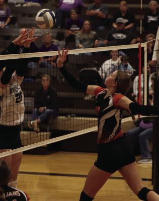Junior Erin Johnson sails to the net to joust for a tight ball against the Southern Valley Eagles.