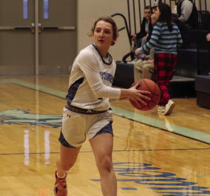 The Roughriders’ Allison Van Pelt pushes the ball up the floor.