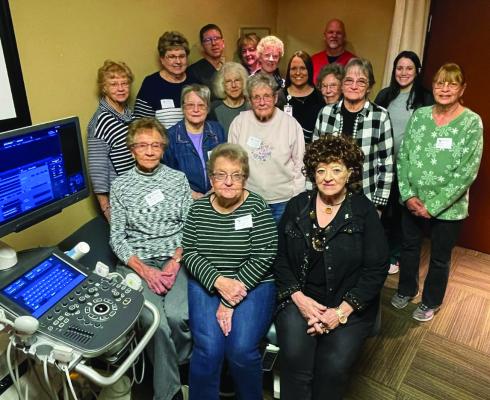 Members of the Cambridge Memorial Hospital Auxiliary are photographed with a piece of ultrasound equipment that pirchased with Thrift Store proceeds.