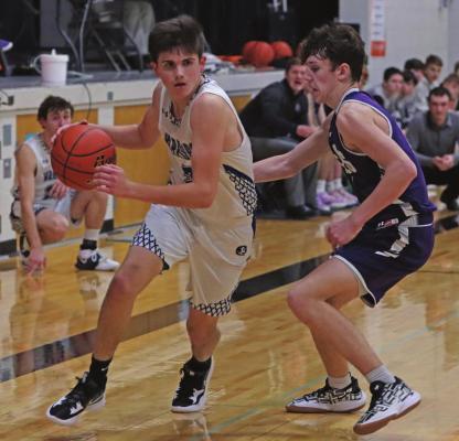 Arapahoe’s Campbell Schutz works on the dribble against Southern Valley’s Kamden Bose.