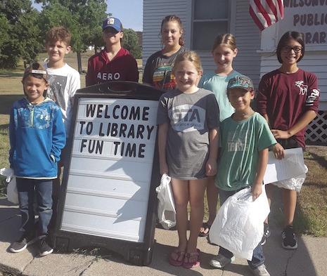 Thanks to the ARPA Formula Grant program. The Wilsonville Library was able to update, and get new equipment. Some of the things purchased were a new computer, a laminator for public use, rolling shelves for our genealogy books. The new sandwich board is shown with the kids who attended our Library Fun Time this summer.