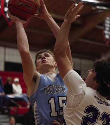 Southwest’s Deric Kelley goes up in the lane against Arapahoe’s Eli Shafer.