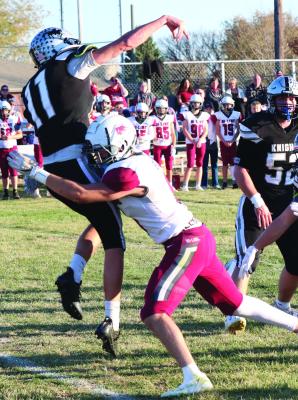 Hi-Line’s Kaden Clouse, who had four tackles for loss against Elmwood-Murdock, takes down the Knights quarterback as he releases a pass Friday.