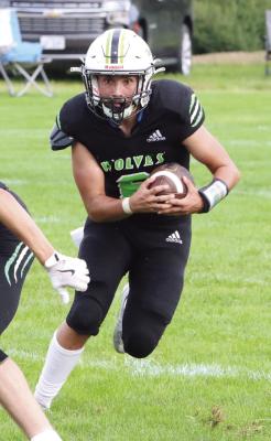 Maywood-Hayes Center’s Kody Schwenk breaks free from the pocket on a run.