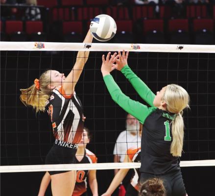 ABOVE: Cambridge’s Breelle Miller terminates at the net. RIGHT: The Trojans’ Schyler Hoberty and Erin Johnson rise to block back a Knights attacker.