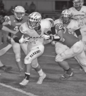 Arapahoe’s Wyatt Jenkins breaks away from an Alma defender on a run Friday night.
