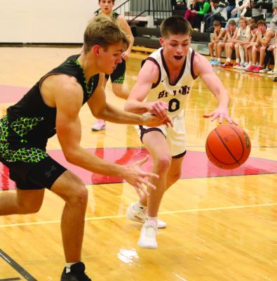 Maywood-Hayes Center’s Haydn Farr and Hi-Line’s Treyton Evans scramble for a loose ball.
