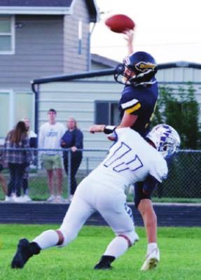 Araaphoe’s Kyle Elliott drills the Elm Creek quarterback as he lets a pass go.