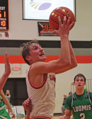 Cambridge's Carson Trompke floats into the lane for a score.
