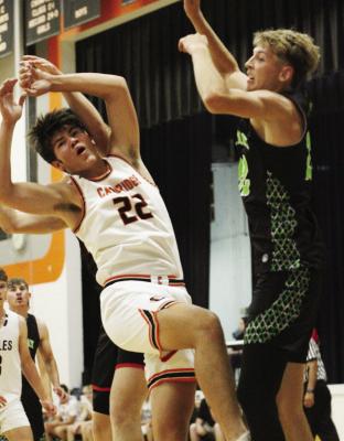 Cambridge’s Brohdey Wood and MHC’s Jeremiah Ingison jump for a loose rebound.