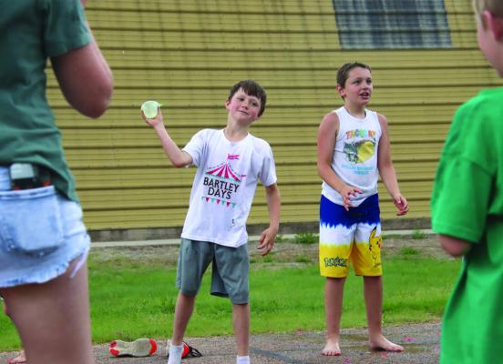 Kids throw water balloons to(or sometimes at) their partners during the Water Balloon Toss.