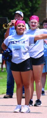 A member of the Southwest Cheerleading Squad accompanies the Southwest Marching Band as it performs “Sweet Caroline” during the Bartley Days parade.