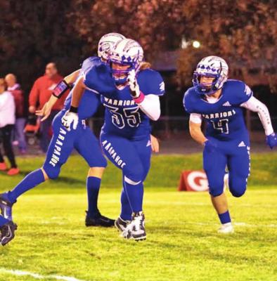 The Warriors’ Rafe Hill breaks from the bakcfield during the first half of Arapahoe’s playoff game Friday.
