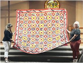 A large quilt made by Martha Bergquist is shown during the Oxford Quilt Group Bed Turning on Monday, September 18. There were several quilts shown at the Evangelical Free Church that day.